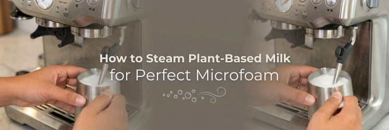 Barista steaming oat milk in a pitcher to create smooth microfoam for a latte art pour