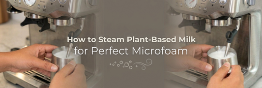 Barista steaming oat milk in a pitcher to create smooth microfoam for a latte art pour